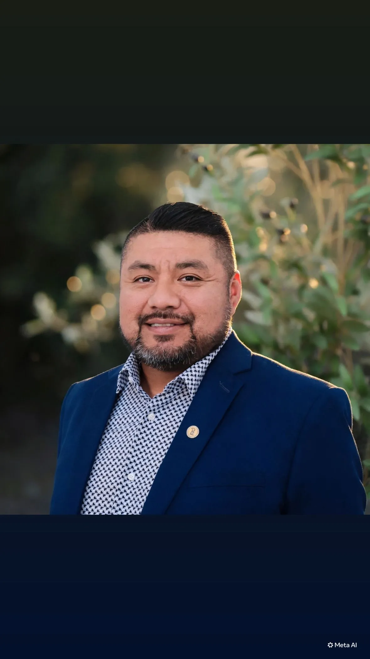 Hugo Paredes in a navy blazer and patterned shirt, standing outdoors